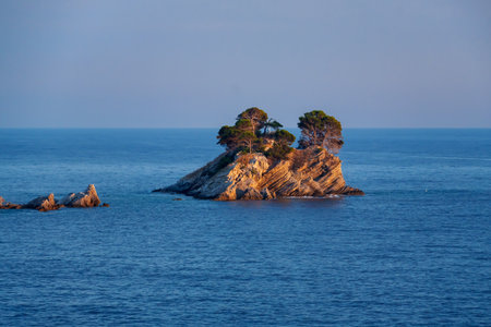 Beautiful seascape with sea view and rocky island at sunset.