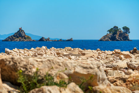 beautiful summer landscape of rocky sea coast and islands, high bank covered with forest and rocks...