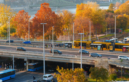 Panoramic view of Budapest and the Danube River at sunset, city architecture, bridges, and road...
