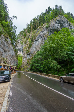 Bicaz canyon, Romania - Juny 28, 2025: mountain road, souvenir shops on the side of the road, people and cars, popular tourist placeのeditorial素材