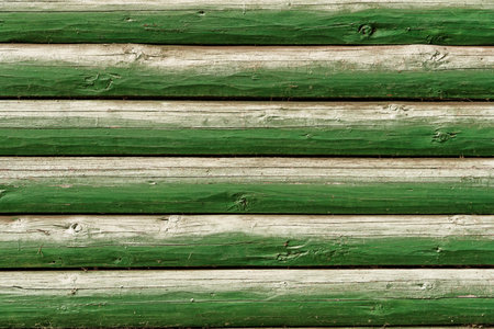 background of old weathered and cracked boards with peeling paint of green colorの写真素材