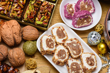 Delicious Turkish delight rolls with hazelnut and pistachio served on white plates with festive...
