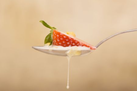Strawberry and cereal on a spoon