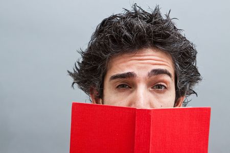Male student reading a suspense novel