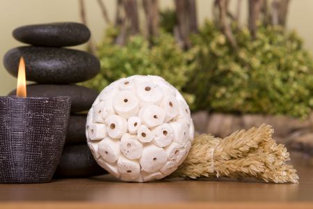 Candle, massage stones in front of a bonsai treeの写真素材