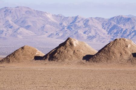Three dirt hills in the desert