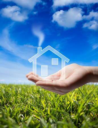 buy home - Icon house in the hand - grass and sky の写真素材