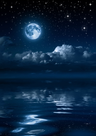 moon and clouds in the night on sea の写真素材