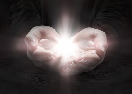 light in hands - pray the crucifix in darkness の写真素材