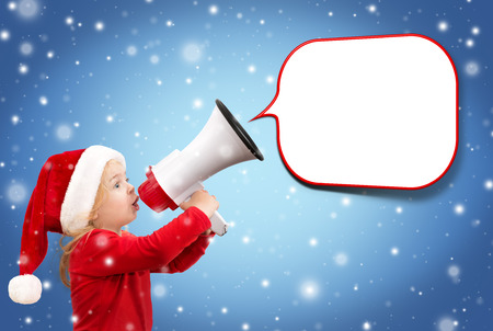 child with megaphone and balloon, snowfall christmas backgroundの写真素材