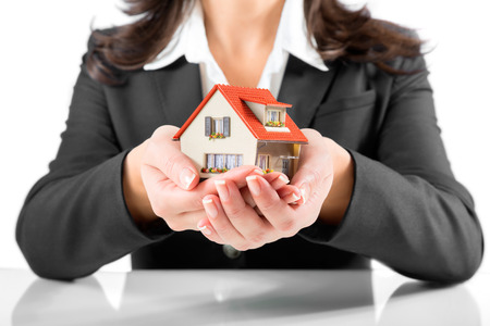 insurance and protection concept - realtor woman Gives a houseの写真素材