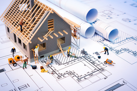 building house on blueprints with worker construction project building house on blueprints with worker construction project