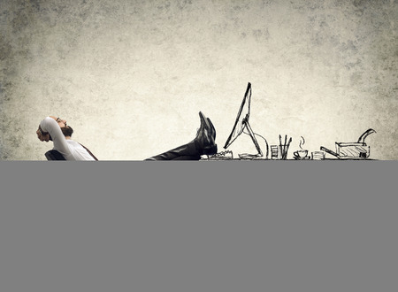 relax in office man sitting on the drawing of desk relax in office man sitting on the drawing of desk