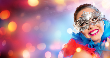 Attractive Woman Smiling With Carnival Maskの写真素材