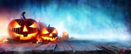 Halloween Pumpkins On Wood In A Spooky Forest At Nightの写真素材