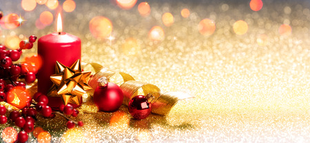 Red Christmas Candle On Golden Ornamentの写真素材