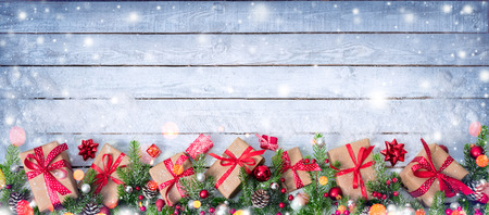 Gift Boxes And Decorated Fir Branches On Snowy Table - Christmas Cardの写真素材
