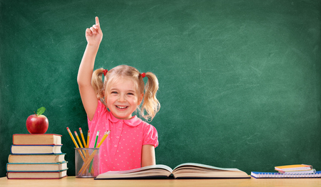 Happy Girl Raising Hand In The Classroomの写真素材