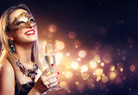 Sensual Woman With Golden Mask And Champagne - Masquerade Partyの写真素材
