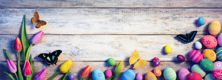 Easter - Tulips With Butterflies And Painted Eggs On Vintage Plankの写真素材