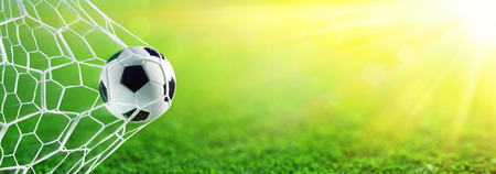 Soccer Ball In Goal With Sunlightの写真素材