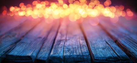 Blurred Christmas Lights on Wooden Table - Defocused Backgroundの写真素材