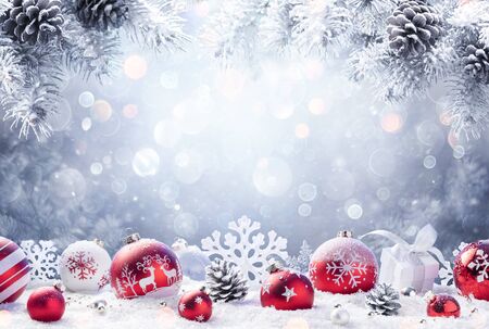 Christmas - Red Ornament On Snow With Fir Branchesの写真素材