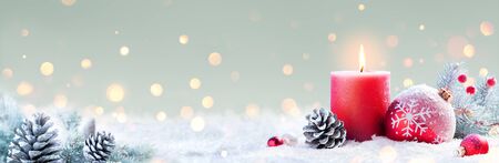 Advent - Red Candle And Christmas Decoration On Snowの写真素材