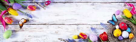 Easter Painted Eggs And Tulips On White Plank