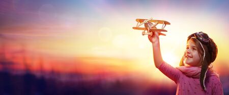 Child Play With Airplane At Sunset-Imagination And Freedom Conceptの写真素材