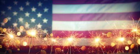 Use Celebration With Sparklers And Blurred American Flag On Vintageの写真素材