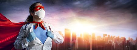 Doctor In Face Mask And Superhero Cape At Sunsetの写真素材