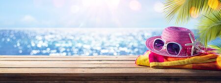 Beach Accessories On Table With Shiny Sea On Backgroundの写真素材