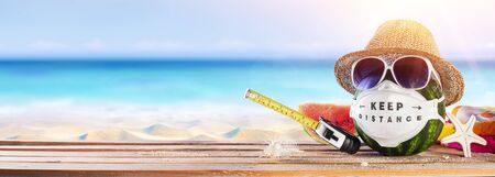 Watermelon Wearing Protective Mask - Keep Social Distance In Beach - Creative Minimal Conceptの写真素材