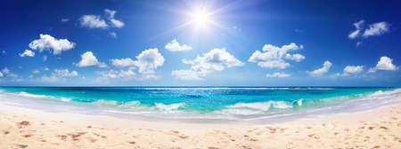 Idyllic Sand Beach With Sun Over Oceanの写真素材