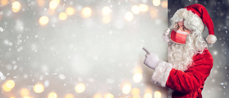Santa Claus With Protective Mask Pointing Blank Billboardの写真素材
