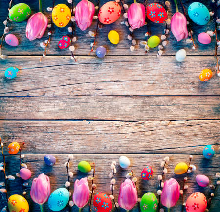 Vintage Easter Decoration - Painted Eggs With Willows Branches And Tulips On Rustic Tableの写真素材