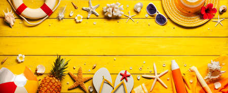 Yellow Beach Background With Accessories On Wooden Tableの写真素材