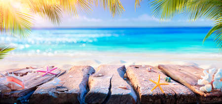 Beach Table With Blurred Ocean And Palm Leaves - Summer Backgroundの写真素材
