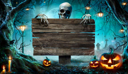 Halloween Party Card - Pumpkins And Skeleton In Graveyard At Night With Wooden Boardの写真素材