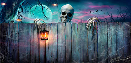 Halloween - Skeleton Holding Lantern On Wooden Banner In Nightの写真素材