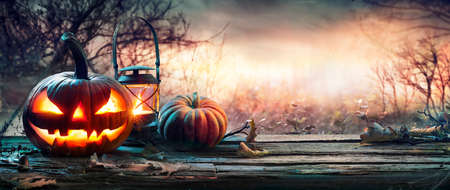Halloween Pumpkin On Table In Spooky Landscapeの写真素材