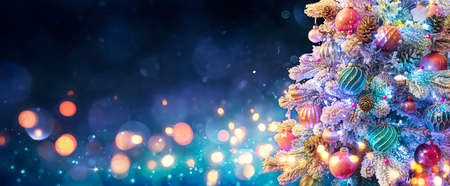 Christmas Tree With Ornaments In Blue Night - Balls On Fir Branches With Defocused Lights In Abstract Backgroundの写真素材