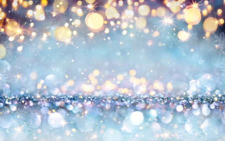 Abstract Magic Christmas Background - Shiny Golden Lights On Silver Blue Glitter With Snowflakes And Starsの写真素材