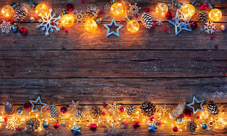 Christmas Lights On Wooden Table - Decorations Illuminated With String Lightsの写真素材