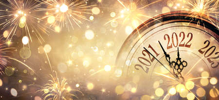 2022 New Year - Clock And Fireworks - Countdown To Midnight - Golden Abstract Defocused Backgroundの写真素材