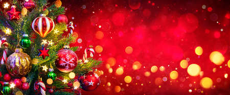 Christmas Tree In Red Background - Ornament And Abstract Defocused Lightsの写真素材
