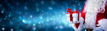 Christmas Present Santa Claus Give Gift With Abstract Lights At Nightの写真素材
