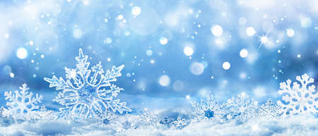 Snowflakes On Snow - Christmas And Winter Background - Natural Snowdrift Close Up With Abstract Lightの写真素材