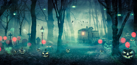Halloween - Haunted House In Spooky Forest At Night With Pumpkins And Ghostsの写真素材